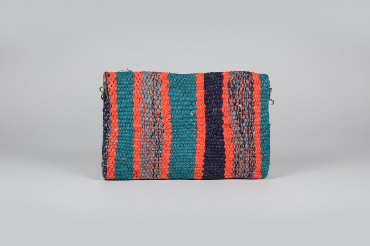 Nora Clutch back view — handmade Berber clutch with blue orange and purple pattern by Studio Palmier